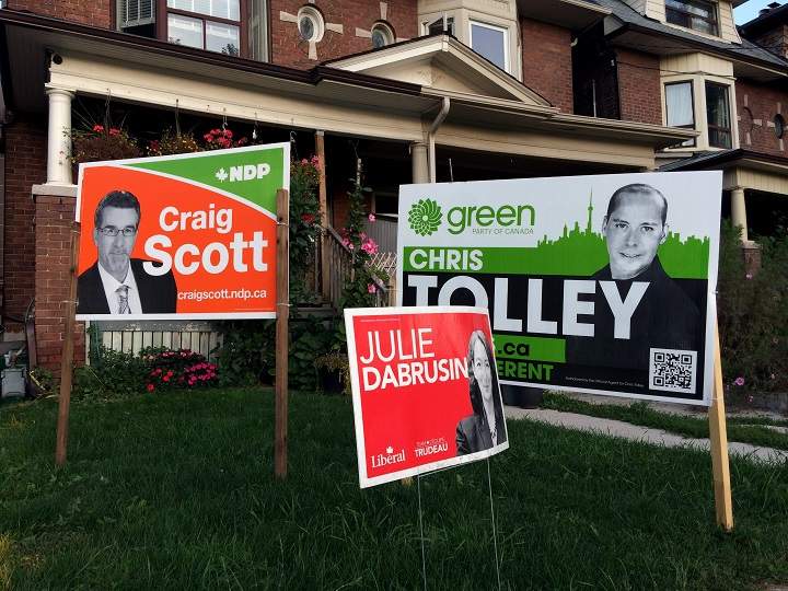 Federal election campaign signs adorn the front lawn of a house in the riding of Toronto-Danforth, in Toronto, Ont., on Oct. 7, 2015. 