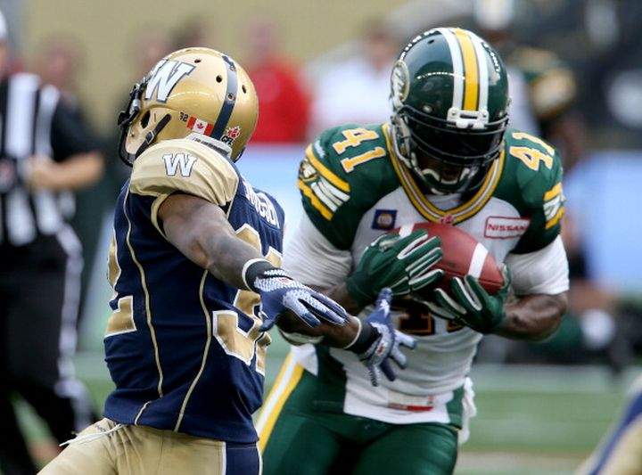 Edmonton Eskimos’ Odell Willis (41), right, intercepts a pass intended for Winnipeg Blue Bombers’ Nic Grigsby (32) during first half CFL Football at Investors Group Field in Winnipeg, Manitoba, Canada.