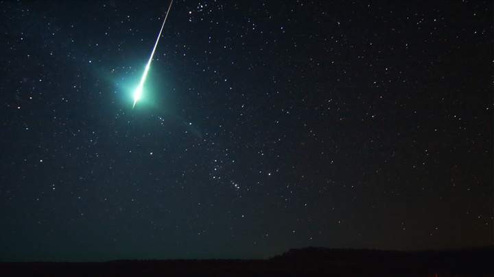 A Taurid fireball, streaks above Orion.
