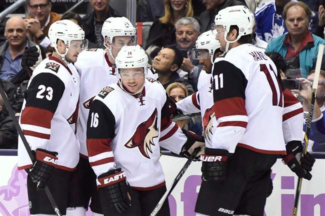 Arizona Coyotes' Max Domi (16) celebrates with teammates.
