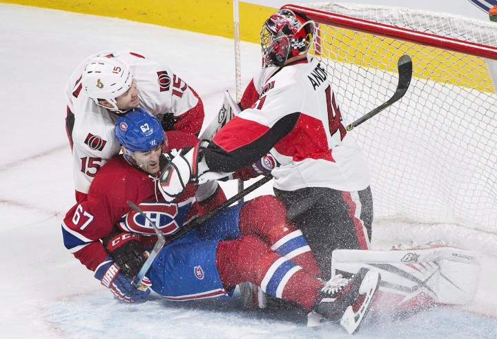 Montreal Canadiens captain Max Pacioretty (67) slides in on Ottawa Senators goaltender Craig Anderson as Senators' Zack Smith (15) defends during second period NHL pre-season hockey action in Montreal, Thursday, October 1, 2015.