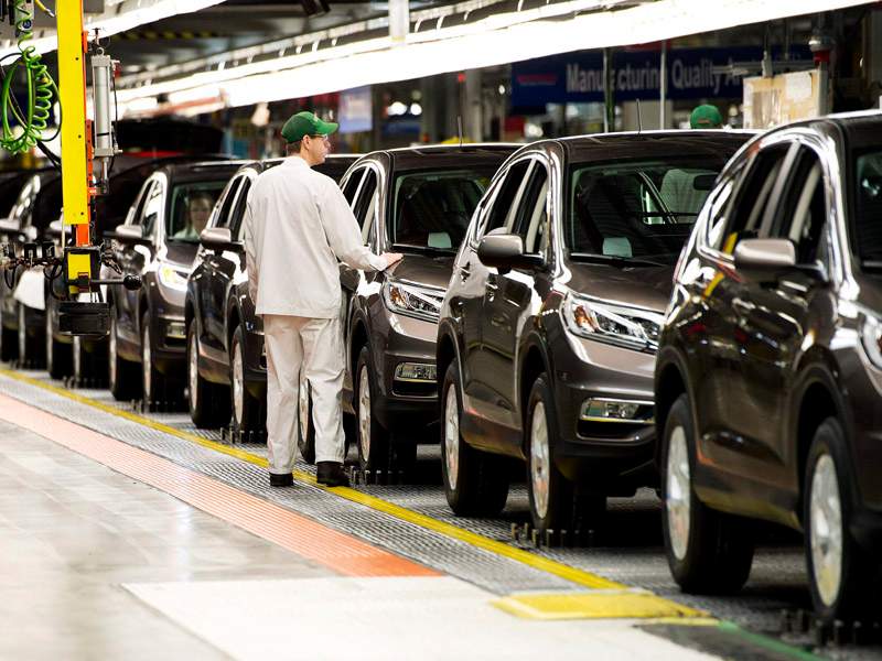Workers inspect vehicles and work on the assembly line at Honda of Canada Mfg. Plant 2 in Alliston, Ont., on Monday, March 30, 2015.