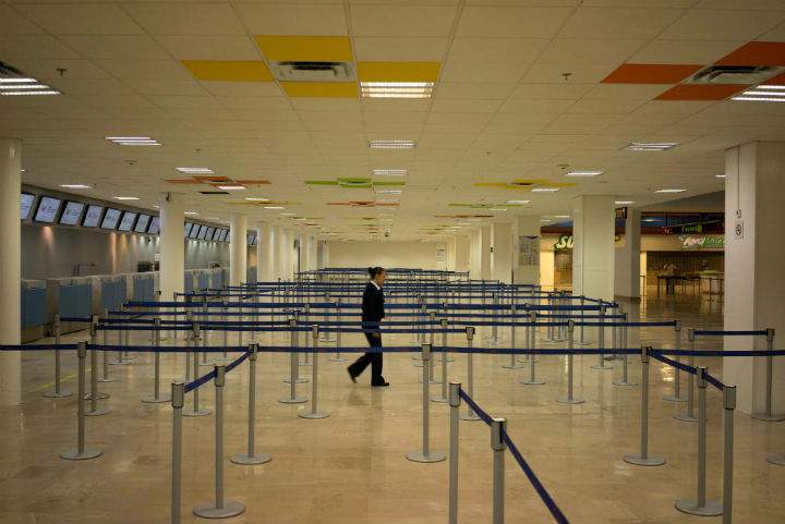 An airline employee walks in the empty airport where all flights are cancelled as Hurricane Patricia approaches the Pacific resort city Puerto Vallarta, Mexico, Friday. Oct. 23, 2015.