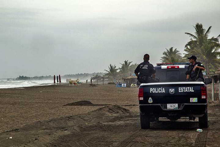Police patrol the beach in Boca de Pascuales, Colima State, Mexico, on October 22, 2015. Fast-moving Patricia grew into an “extremely dangerous” major hurricane off Mexico’s Pacific coast on Thursday, forecasters said.