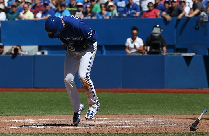Troy Tulowitzki of the Toronto Blue Jays reacts after being hit by pitch in the seventh inning during MLB game action against the Kansas City Royals on August 2, 2015 at Rogers Centre in Toronto.