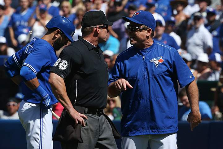 Home plate umpire Jim Wolf listens to objections from manager John Gibbons of the Toronto Blue Jays after ejecting him in the seventh inning against the Kansas City Royals during MLB game action on August 2, 2015 at Rogers Centre in Toronto.