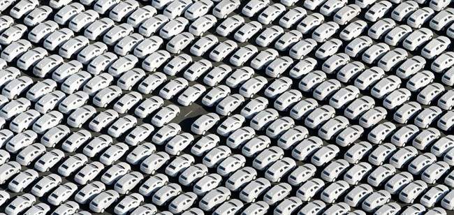 In this Sept. 30, 2015 file photo new cars of Volkswagen AG stand at the car terminal in Emden, Germany. 