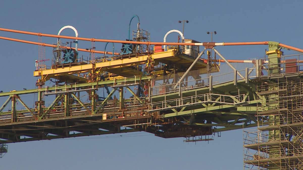 Crews are seen working on the gantry on the Macdonald Bridge. 