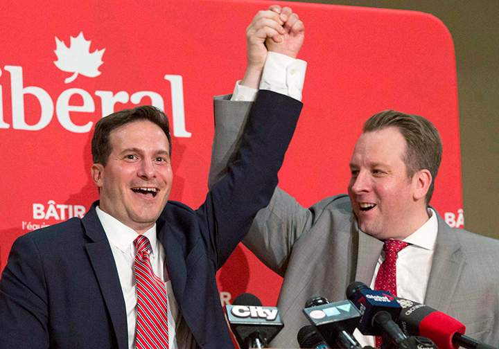 Marco Mendocino, left, has his hand held high by Party Chair Tyler Banham after Mendocino won the Liberal nomination for the Toronto riding of Eglinton-Lawrence on Sunday, July 26, 2015.