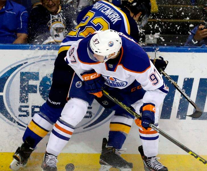 Edmonton Oilers' Connor McDavid, front, collides with St. Louis Blues' Kevin Shattenkirk along the boards during the first period of an NHL hockey game Thursday, Oct. 8, 2015, in St. Louis. (AP Photo/Jeff Roberson).