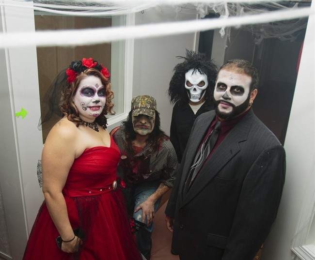 Jennifer Hornacek and Arturo Mendez pose for portrait after their Day of the Dead-themed wedding ceremony on Wednesday, Oct. 28, 2015 at The Haunted Eclectic Marketplace in Ludington, Mich. 