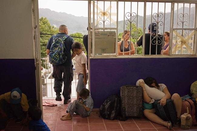 People wait for the arrival of Hrricane Patricia at a shelter in the Pacific resort city of Puerto Vallarta, Mexico, Friday, Oct. 23, 2015.