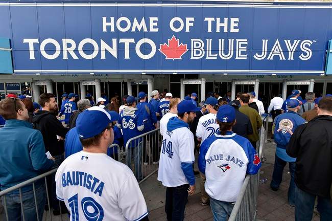 Fans arrive for game one of the Toronto Blue Jays and Texas Rangers American League Division Series in Toronto on Thursday, Oct.8, 2015. THE CANADIAN PRESS/Nathan Denette.