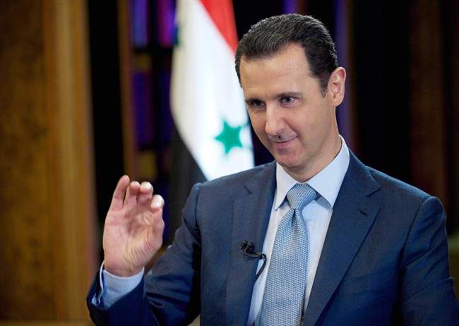 In this Tuesday, Feb. 10, 2015, file photo released by the Syrian official news agency SANA, Syrian President Bashar Assad gestures during an interview with the BBC in Damascus, Syria.