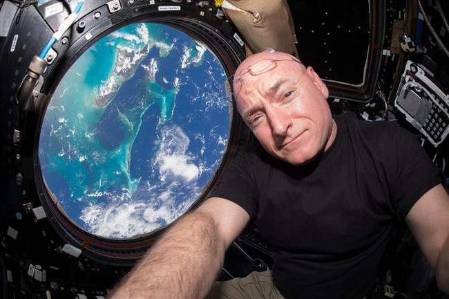 Scott Kelly poses for a selfie photo in the “Cupola” of the International Space Station with the Bahamas seen below. Kelly was part of a one-year mission to better understand health effects of long-duration space travel.