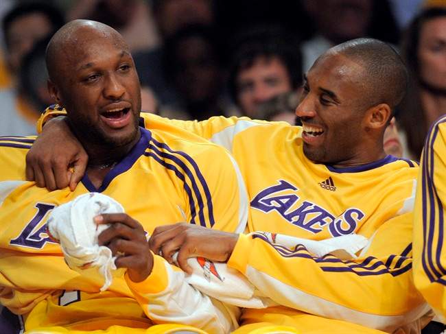 In this Nov. 18, 2008, file photo, Los Angeles Lakers guard Kobe Bryant, right, talks with forward Lamar Odom. 
