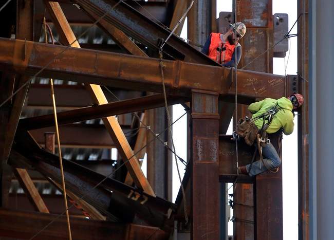 Iron workers help to build a new technology centre for Comcast in Philadelphia.
