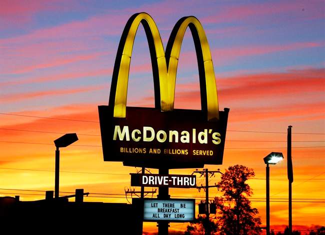 In this Saturday, Oct. 10, 2015 photo, the sun sets behind a McDonald's restaurant in Ebensburg, Pa.