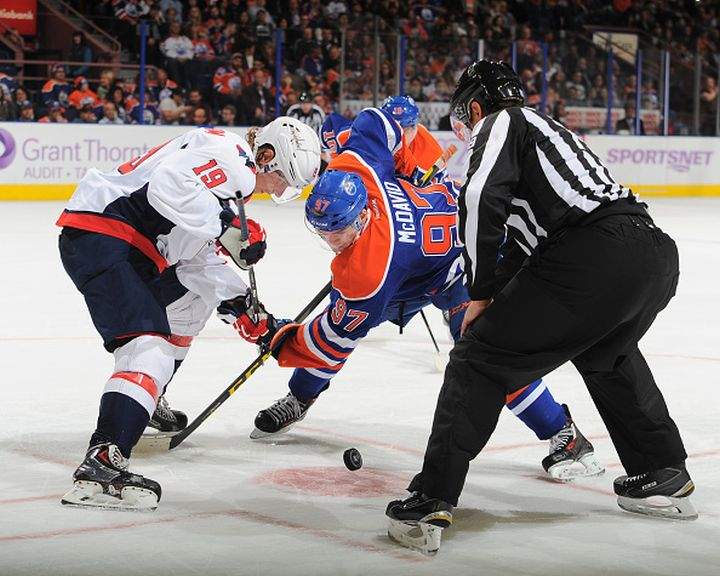 Connor McDavid #97 of the Edmonton Oilers takes a face off against Nicklas Backstrom #19 of the Washington Capitals on October 23, 2015 at Rexall Place in Edmonton, Alberta, Canada.
