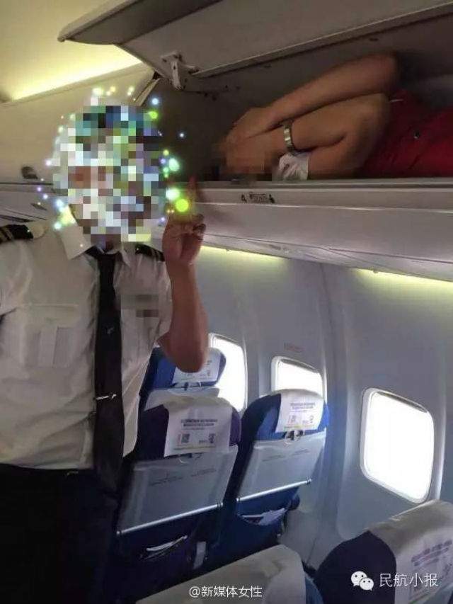 One of the photos posted to the Civil Aviation Tabloid account on Weibo purportedly showing a Kunming Airlines flight attendant in the overhead baggage compartment as another crew member poses for the photograph.