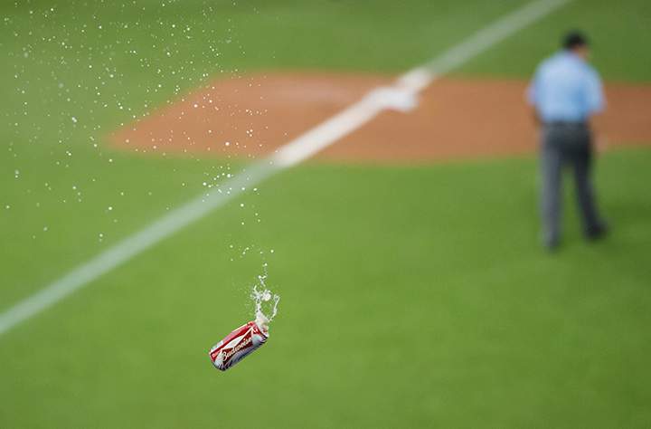 A beer is thrown onto the field toward the umpire crew during seventh inning game five American League Division Series baseball action between the Toronto Blue Jays and the Texas Rangers in Toronto on Wednesday, October 14, 2015.