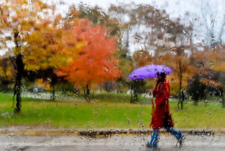 A women makes her way through the wet, rainy weather in Toronto on Wednesday, October 28, 2015.