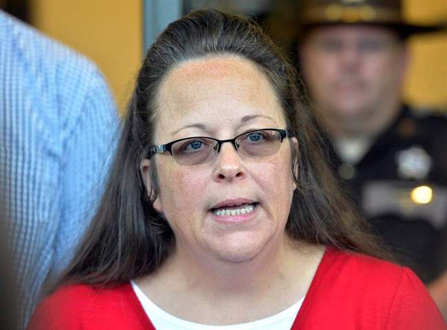 FILE - In this Sept. 14, 2015 file photo, Rowan County Clerk Kim Davis makes a statement to the media at the front door of the Rowan County Judicial Center in Morehead, Ky. On Friday, Oct. 2, 2015, the Vatican distanced Pope Francis from Kim Davis, the focal point in the gay marriage debate in the U.S., saying she was one of dozens of people the pope greeted in the U.S. and that their Sept. 24 encounter at the Vatican's embassy in Washington "should not be considered a form of support of her position." Davis, an Apostolic Christian, spent five days in jail for defying a series of federal court orders to issue same-sex marriage licenses after the Supreme Court legalized gay marriage across the country. (AP Photo/Timothy D. Easley, File).