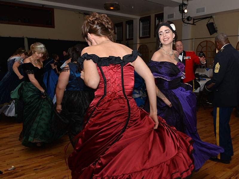 Women wearing 1860 period dresses dance to music played by Fort Wainwright's 9th Army Band, Saturday, Oct 17, 2015 in Allen Hall in Sitka, Alaska, during the Alaska Day Festival celebration. 