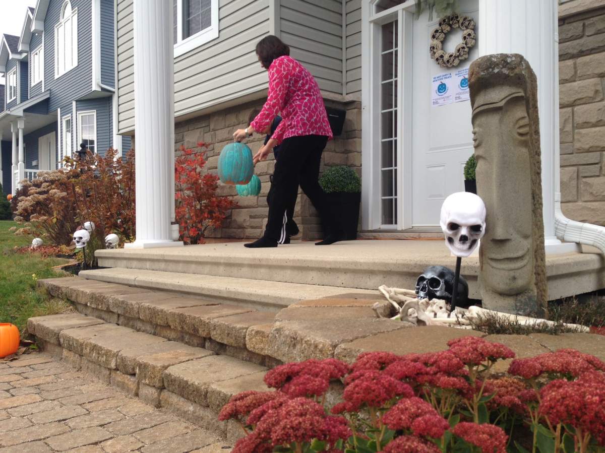 Angela Harris and her son, Campbell, put teal pumpkins outside their home to let children with allergies know they can trick or treat at their home.