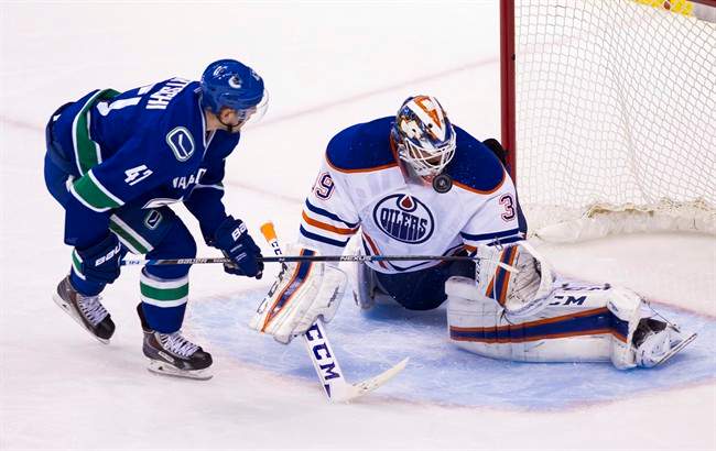 Edmonton Oilers goaltender Anders Nilsson (39) makes a save against Vancouver Canucks Sven Baertschi (47) during the second period of an NHL hockey game in Vancouver, B.C., on Sunday October 18, 2015. 
