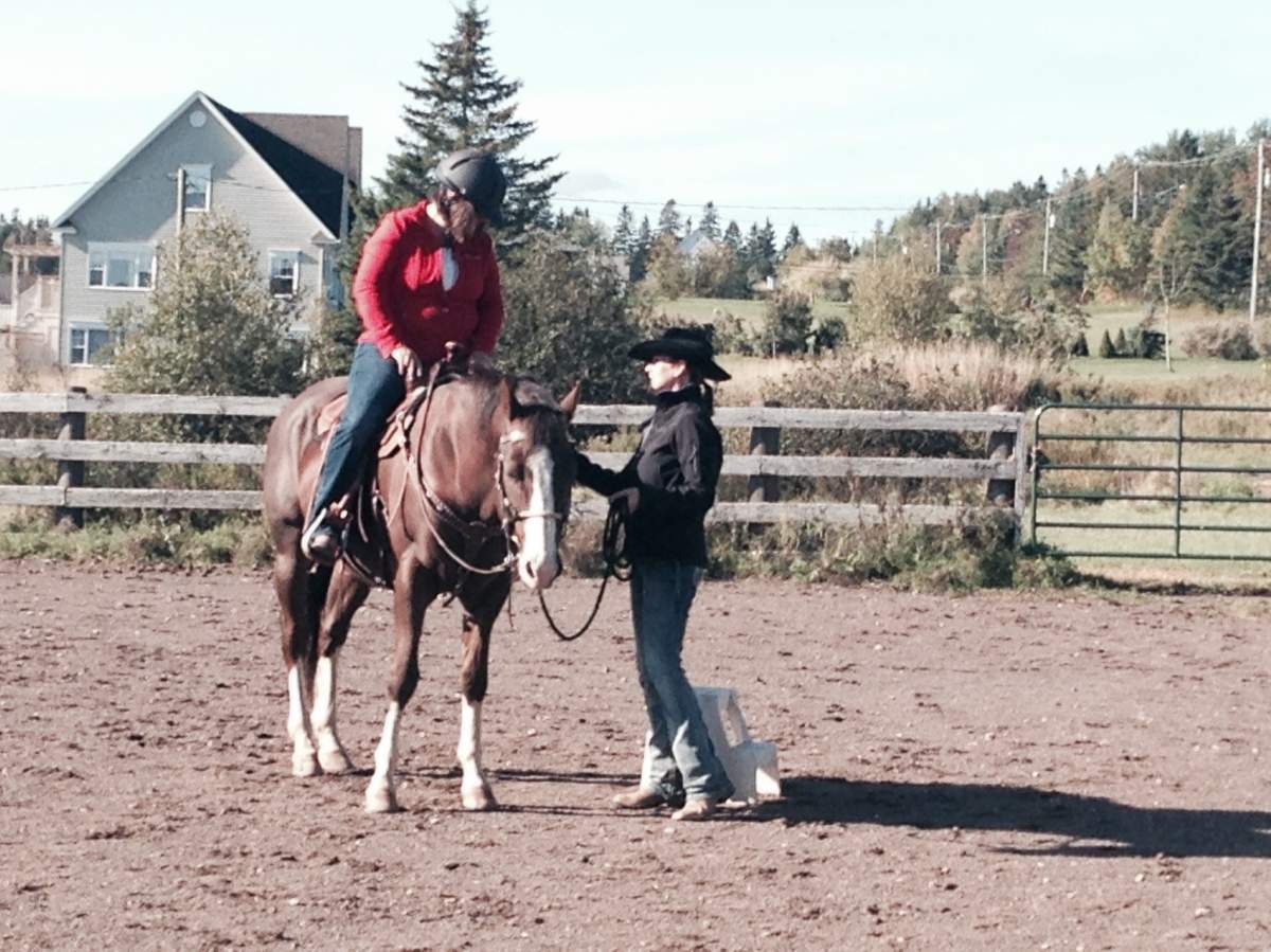 Monique Barlett gets a lesson from therapeutic riding instructor Terry Nichols.
