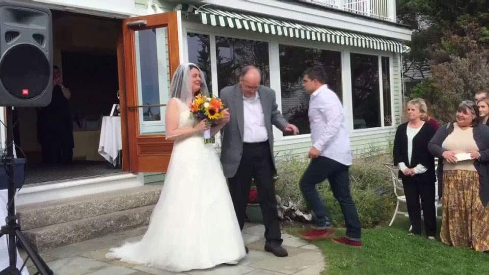 Wheelchair-bound father surprises daughter, walks her down aisle - image