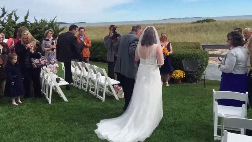 Wheelchair-bound father surprises daughter, walks her down aisle - image