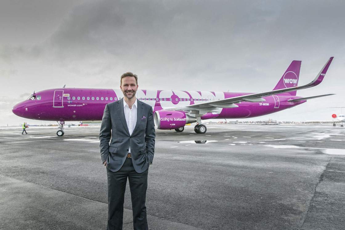 WOW Air chief Skuli Mogensen stands in front of one the airline's Airbus A321 aircraft.