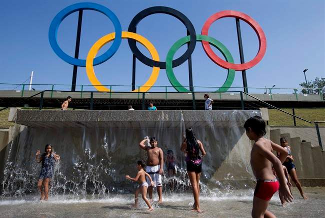 In this July 28, 2015 file photo, children play in a water fountain next to Olympic rings at Madureira Park in Rio de Janeiro, Brazil.