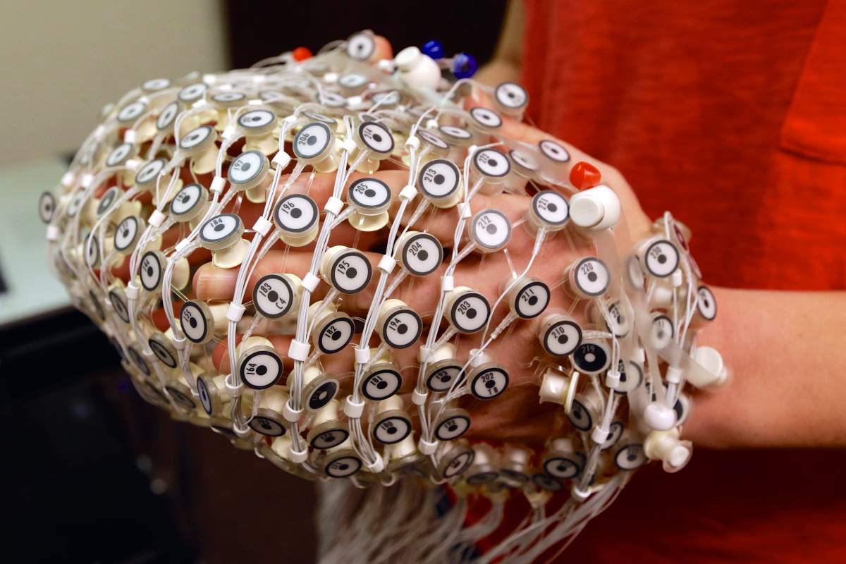 An EEG net for detecting brain activity is being prepared for use by research assistant Sara Mason at the University of Nebraska's Center for Brain, Biology and Behavior in Lincoln, Neb.