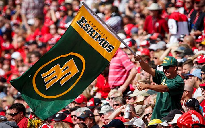 An Edmonton Eskimos' fan cheers during first half CFL football action against the Calgary Stampeders in Calgary, Alta., Monday, Sept. 1, 2014.