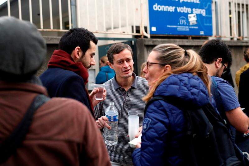People line up to give blood at the St Louis hospital across the street from the Petit Cambodge restaurant in Paris Saturday Nov. 14, 2015, a day after over 120 people were killed in a series of shooting and explosions.