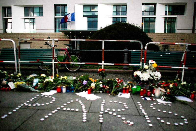 People have placed flowers and candles to mourn for the victims killed in the Friday’s attacks in Paris, France, in front of the French Embassy in Berlin, Saturday, Nov. 14, 2015.