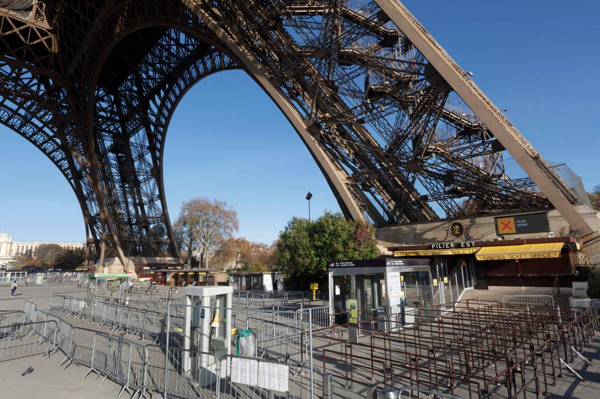 The Eiffel Tower remained closed on the first of three days of national mourning in Paris, Sunday, Nov. 15, 2015. Thousands of French troops deployed around Paris on Sunday and tourist sites stood shuttered in one of the most visited cities on Earth while investigators questioned the relatives of a suspected suicide bomber involved in the country’s deadliest violence since World War II.