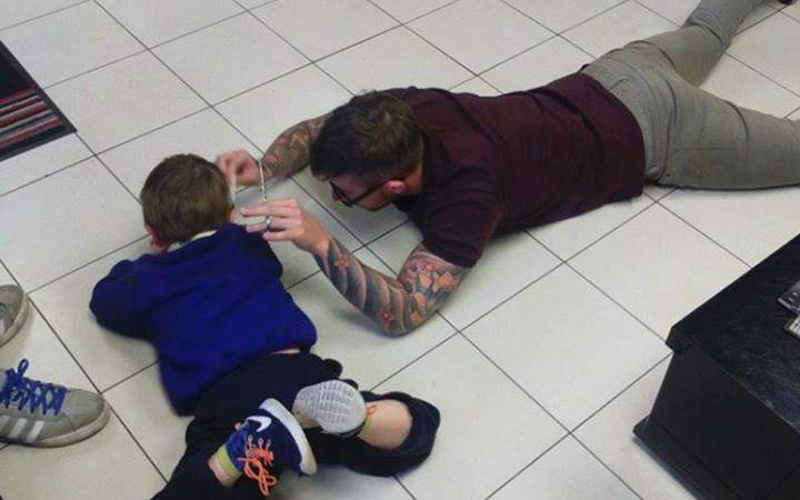 James Williams, owner of ‘Jim the Trim’ in Briton Ferry, Wales gives a haircut to Mason Lewis on Nov. 3, 2015.