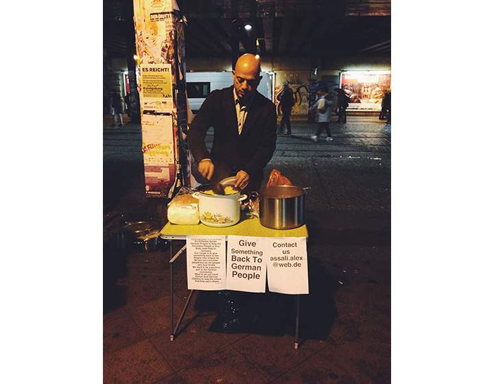 Alex Assali sets up a food station where he dishes out warm meals to the Berlin’s homeless.