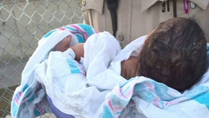 Newborn baby found buried alive, deputy cradles little girl until she stops crying - image