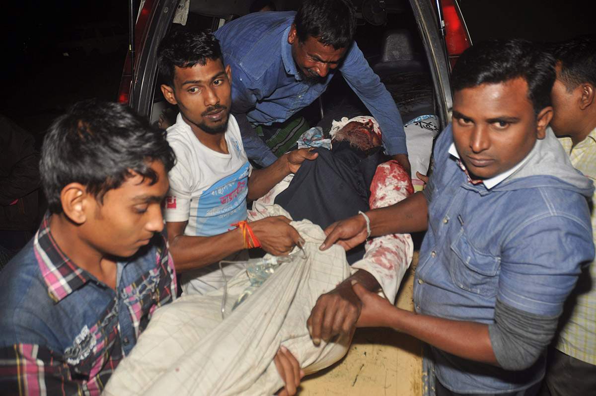 A man injured in an attack on a Shiite mosque is carried for treatment in Bogra district, Bangladesh, Thursday, Nov. 26, 2015.