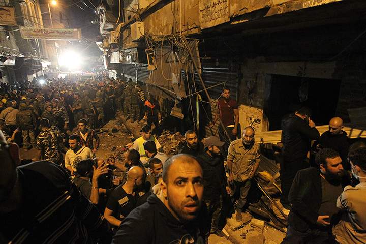 Emergency personnel gather at the site of a twin suicide bombing in Burj al-Barajneh, in the southern suburb of Lebanon’s capital Beirut on November 12, 2015.