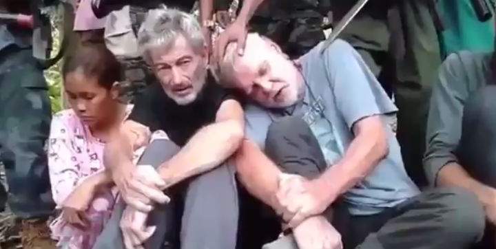 The terror group Abu Sayyaf is demanding more than $100 million for the release of four hostages, including Canadians Robert Hall (centre) John Risdel (right) and Hall's girlfriend Teresita Flor. 