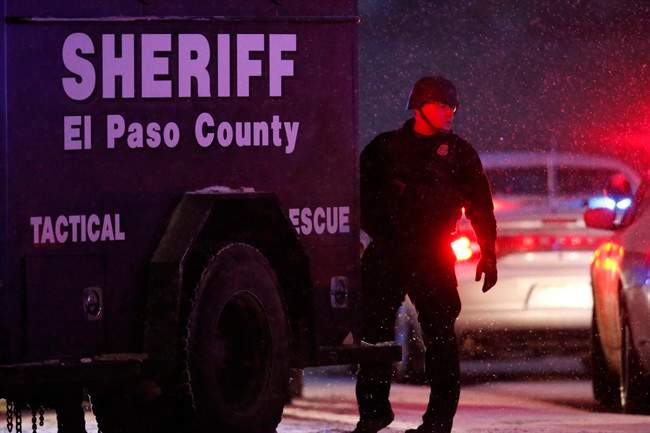 Police stand guard after a suspect was apprehended Friday, Nov. 27, 2015, in northwest Colorado Springs, Colo. A gunman opened fire at a Planned Parenthood clinic on Friday, authorities said, wounding multiple people. 