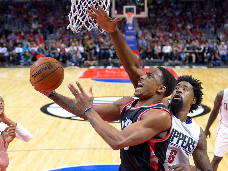 Toronto Raptors guard DeMar DeRozan shoots as Los Angeles Clippers center DeAndre Jordan defends during the first half of an NBA basketball game Sunday, Nov. 22, 2015, in Los Angeles.