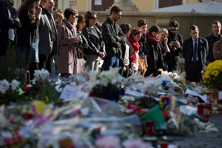 People mourn in front of the French Embassy, in Rome on Nov. 16, 2015 during a Europe-wide minute of silence to honour the victims of the terror attacks in Paris.