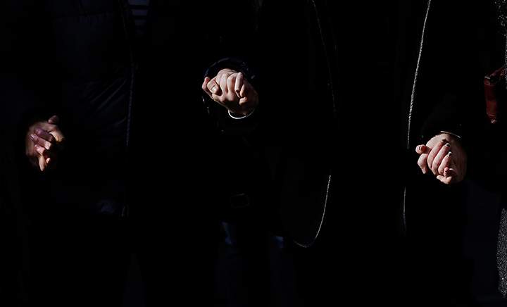 People hold hands as they observe a minute of silence in Lyon, central France, Monday, Nov. 16, 2015, three days after the Paris attacks.